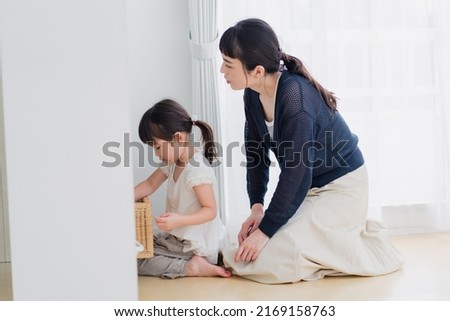 Mother playing with her child at home