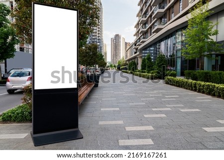 LCD screen billboard for outdoor advertising on a city street. White screen, you can insert your picture here. Royalty-Free Stock Photo #2169167261