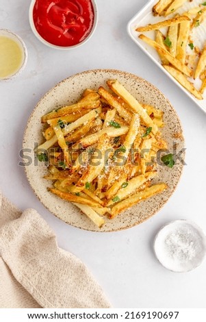 French fries or potato chips with ketchup, homemade roasted in the oven, homemade fries Royalty-Free Stock Photo #2169190697