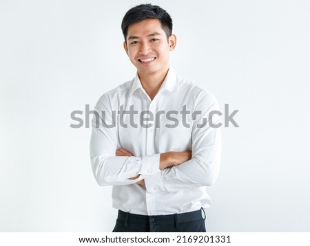 Young, handsome and friendly face man smile, dressed casually with happy and self-confident positive expression with crossed arms on white background studio shot. Concept for good attitude boy.