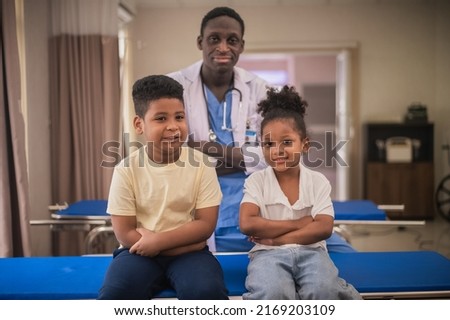 African American pediatric doctor with kids patient in hospital, African American male pediatrician