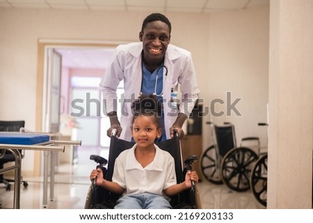 African American pediatric doctor with kids patient in hospital, African American male pediatrician Royalty-Free Stock Photo #2169203133
