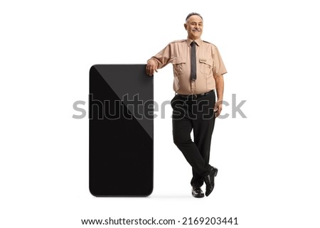 Security officer leaning on a big mobile phone and pointing isolated on white background