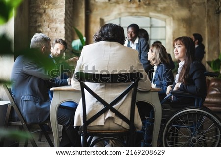 Multiracial business people working inside office - Focus on asian woman sitting on wheelchair