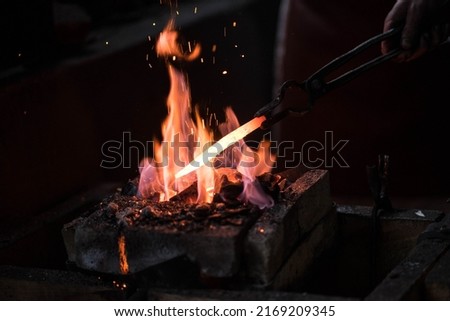 bright fire in the forge with sparks Royalty-Free Stock Photo #2169209345