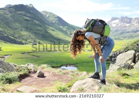 Profile of an exhausted hiker resting after climbing a mountain Royalty-Free Stock Photo #2169210327