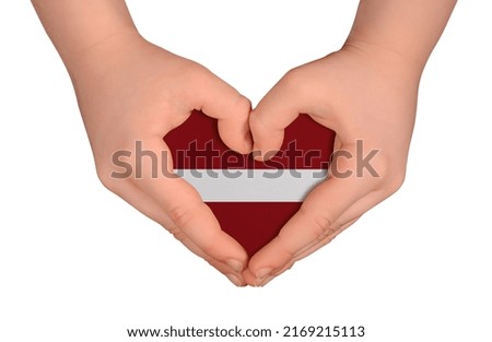 Kid's hands in heart- form. National peace concept on white background. Latvia