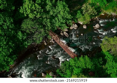 Aerial view of fast river flow through the rocks and green forest. summer in Jermuk. top, aerial view. drone point of view. 
