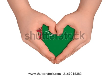 Kid's hands in heart- form. National peace concept on white background. Turkmenistan