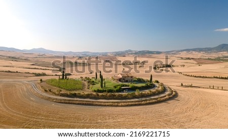 A Tuscan villa in the middle of a field, Val d'Orcia, Italy Royalty-Free Stock Photo #2169221715