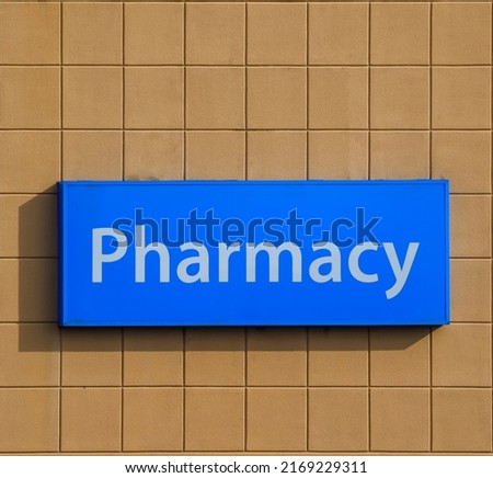 Pharmacy sign at storefront. Facade of a Drugstore.