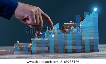 The ring finger walked on the stack of wood like a ladder. concept of ascent to success in business finance Royalty-Free Stock Photo #2169233199