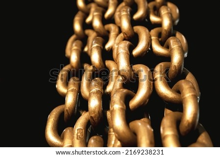 Large, soldered chains on a black background, close-up