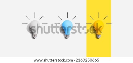 Idea and creativity concept with white, blue and yellow light bulbs - Flat lay