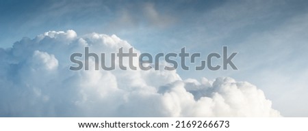 Epic storm cloudscape. White ornamental sunset cumulus clouds. Soft sunlight, sun rays. Clear blue sky. Natural pattern, texture, background, wallpaper, 3D, graphic resources, design, copy space Royalty-Free Stock Photo #2169266673