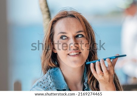 woman with mobile phone sending voice message