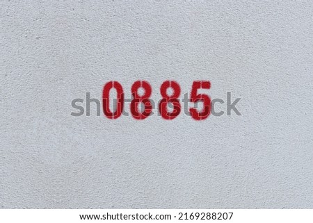 Red Number 0885 on the white wall. Spray paint.
