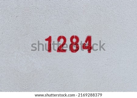 Red Number 1284 on the white wall. Spray paint.
