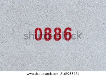 Red Number 0886 on the white wall. Spray paint.
