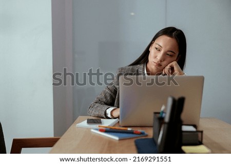 Portrait of tired beautiful business asian woman working in office use computer and looking away