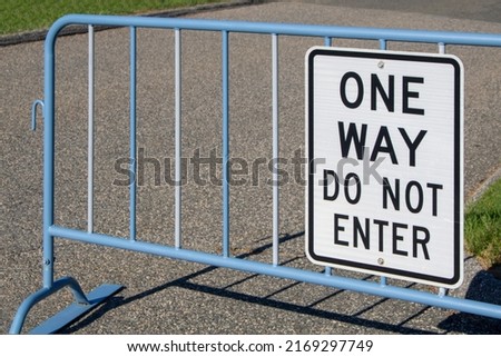 one way do not enter outdoor black and white street message sign