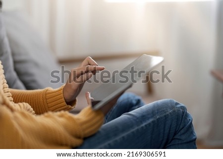 Woman pointing on digital tablet screen, chatting in social networks, meeting website, searching internet, sending sms, using text messenger or online banking. Close up photo.