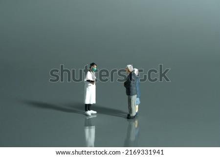 Miniature people toys conceptual photography. Elderly couple with woman doctor. Medication and health check-up concept. Image photo