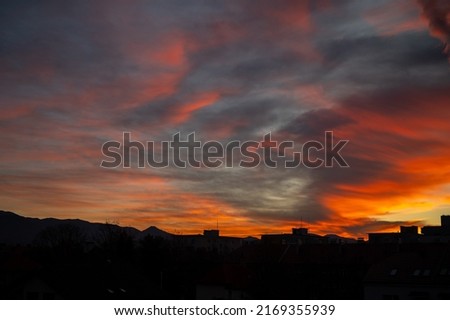 Red sky background with tiny clouds. Sunset time