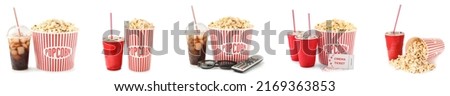 Set of tasty popcorn in buckets and cold cola drinks with cinema tickets, TV remote control and 3D eyeglasses on white background Royalty-Free Stock Photo #2169363853