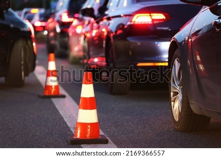 Warning cones on the road during Evening traffic jams during the traffic rush Royalty-Free Stock Photo #2169366557