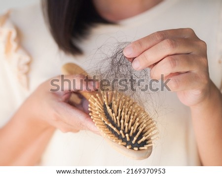 Healthcare concept.Closeup hair loss,hair fall in hairbrush stress problem of woman. Royalty-Free Stock Photo #2169370953