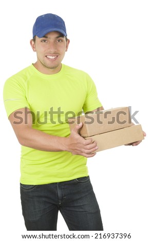 handsome friendly brunette delivery man carrying small boxes isolated on white