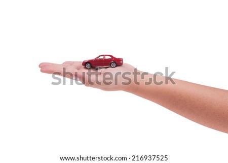 Red model car on hand isolated on white background