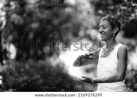 Energy work and mindfulness practice. Young woman doing energy work in a forest