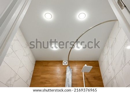 Stretch ceiling in the bathroom with built-in lighting. Royalty-Free Stock Photo #2169376965