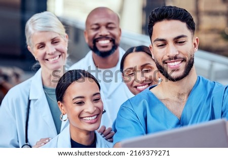 We make a great team. Shot of a group of doctors taking a selfie in the city.