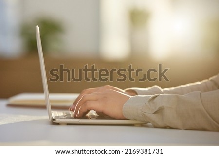 Drafting client emails. Cropped shot of an unrecognizable businessman sitting alone in the office and using his laptop. Royalty-Free Stock Photo #2169381731