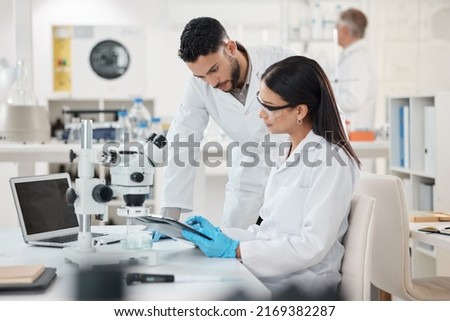 Sharing viewpoints on the days discoveries. Shot of two scientists working together in a lab. Royalty-Free Stock Photo #2169382287