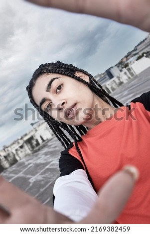 Picture me rolling. Cropped portrait of an attractive young female dancer taking a selfie while standing on a rooftop against a stormy backdrop.
