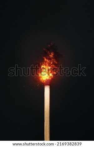 A matchstick set against a dark background with fire effect created in photoshop. Copy space available