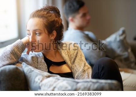 Going through a rough patch. Shot of a young woman looking despondent after a fight with her boyfriend. Royalty-Free Stock Photo #2169383099