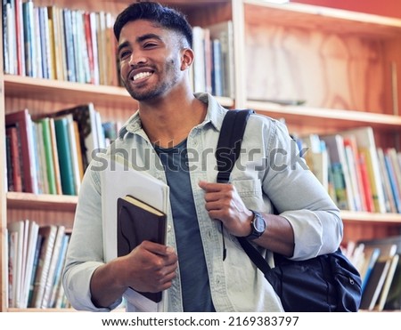 Get studying and go places. Shot of a young man studying in a library at university. Royalty-Free Stock Photo #2169383797