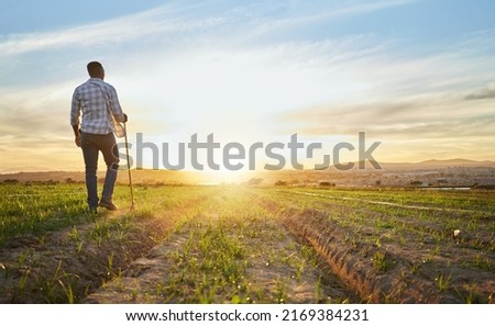 Ive been farming on these lands since I was boy. Shot of a farmer standing on a field. Royalty-Free Stock Photo #2169384231