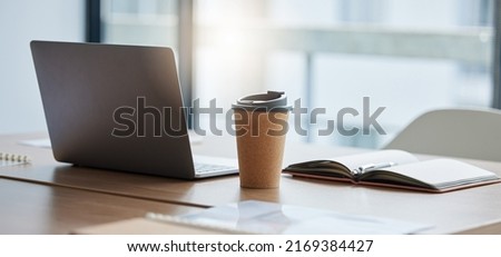 Setting up for a busy day ahead. Shot of a neatly arranged work station in a modern office. Royalty-Free Stock Photo #2169384427