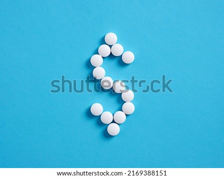 US dollar sign or symbol made with medical pills. Health care medicine expenses concept.