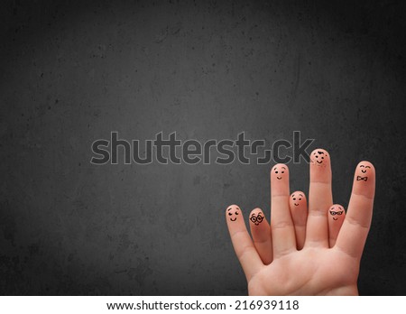 Happy finger smileys faces on hand with empty copy space dark background