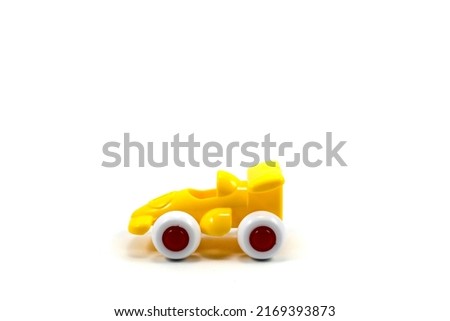 Yellow paint plastic toy racing car with number one isolated on white background