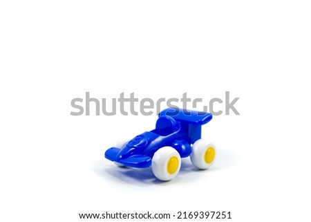 Blue paint plastic toy racing car with number three isolated on white background.