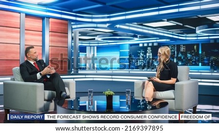 Talk Show TV Program Presenter and Celebrity Interview. Host and Guest Discuss Politics, Economy, Science, News, Entertainment. Mock-up of Cable Channel Studio. Wide Shot, Television Concept Royalty-Free Stock Photo #2169397895