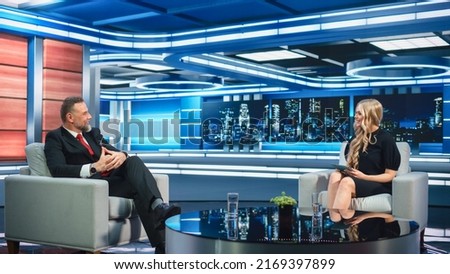 Talk Show TV Program Presenter and Celebrity Interview. Host and Guest Discuss Politics, Economy, Science, News, Entertainment. Mock-up of Cable Channel Studio. Wide Shot, Television Concept Royalty-Free Stock Photo #2169397899